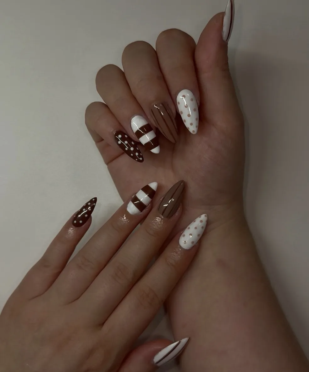Almond nails in brown and white with stripes and polka dots