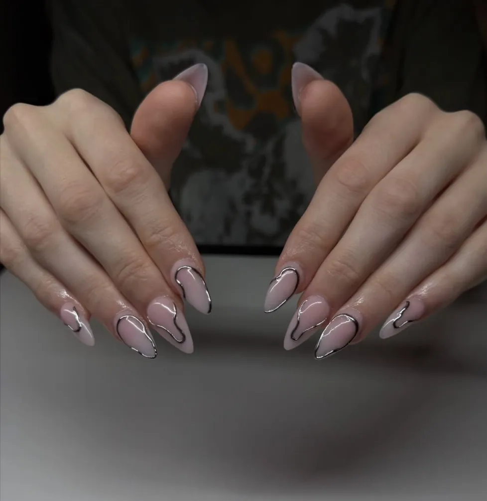 Almond nails with chrome liquid outlines on a sheer pink base
