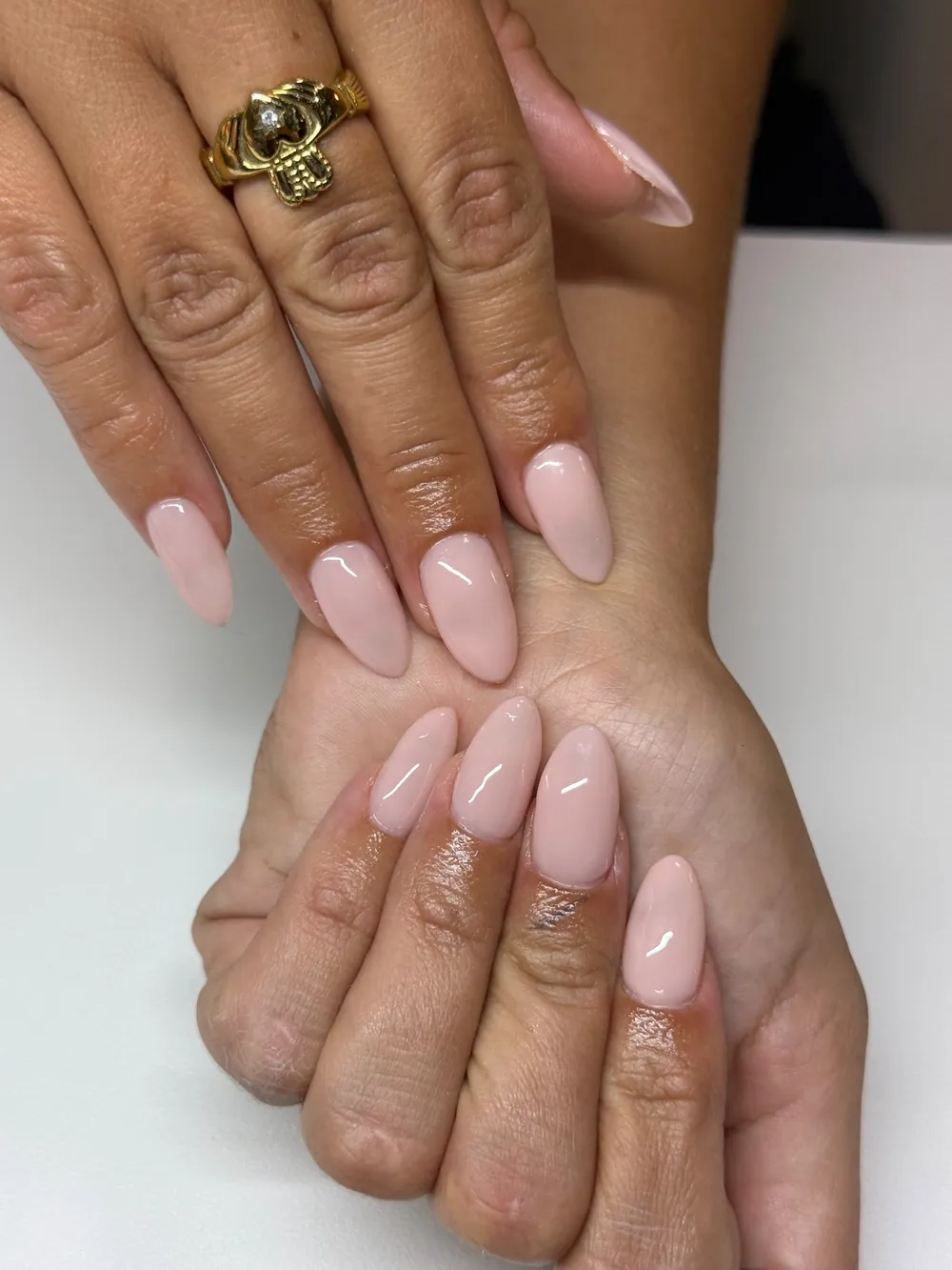 Glossy almond nails in a soft nude pink